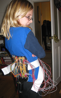 Laura Bird wearing the portable circuitry and 4x4 vibrotactile array (December 2008). Photo by Jon Bird.